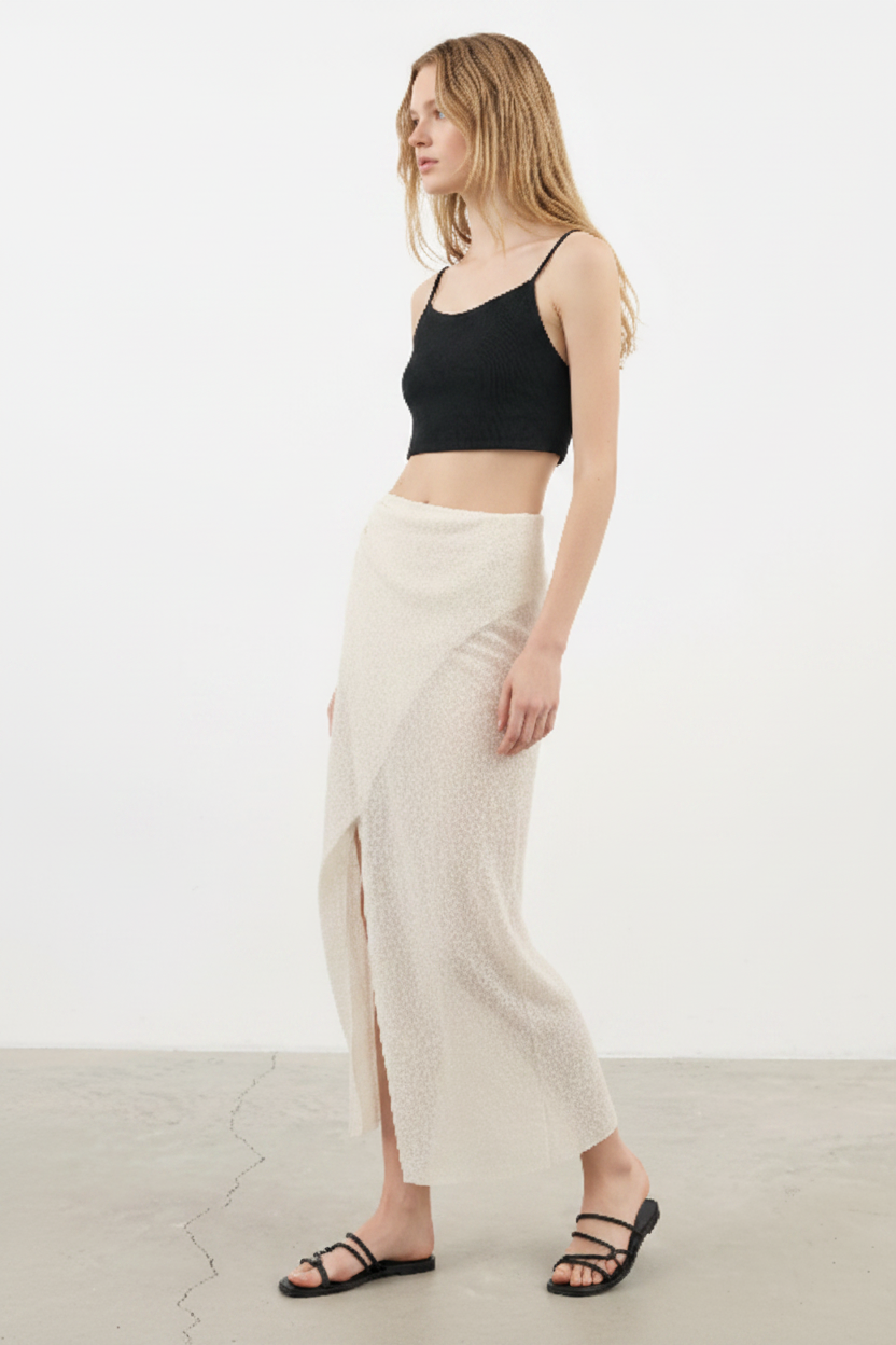 Luxury Beach Wrap Skirt Set in Soft Ivory Sand - Angled Editorial Pose
