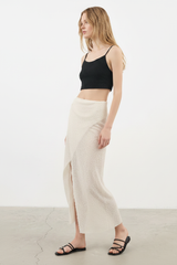 Luxury Beach Wrap Skirt Set in Soft Ivory Sand - Angled Editorial Pose