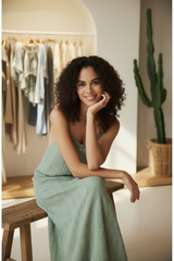 Model wearing Sage Green Boho Striped Maxi Dress - seated pose